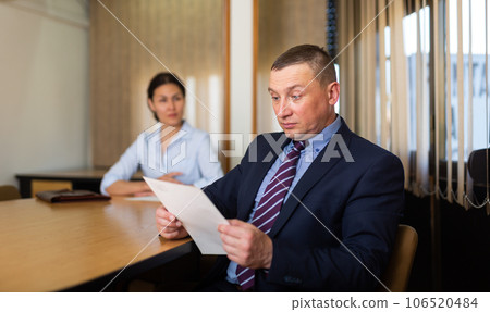 Woman boss firing upset adult male employee 106520484