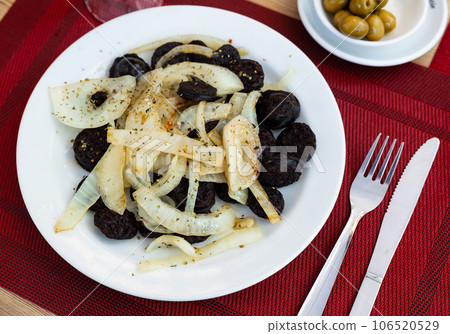 Morcilla con cebolla - traditional Spanish sausage from blood closeup Morcilla con cebolla - traditional Spanish sausage from blood closeup 106520529