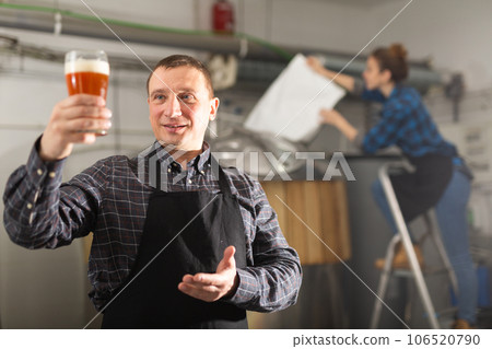 Portrait of man brewmaster with glass of beer 106520790