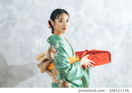 A woman in Japanese clothing with a wrapping cloth A woman in Japanese clothing with a wrapping cloth 106521136