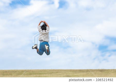 boy jumping on hill 106521492