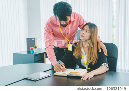 Boss or supervisor touching female employee's shoulder Causing young employees to resist because they are uncomfortable and afraid of being sexually abused. Concept of sexual harassment in the 106521949