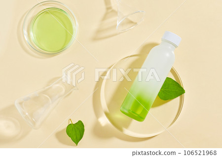 Blank label bottle put on transparent podium, displayed with laboratory glassware. Fish mint (Houttuynia cordata) can strengthen immune systems Blank label bottle put on transparent podium, displayed with laboratory glassware. Fish mint (Houttuynia cordata) can strengthen immune systems 106521968