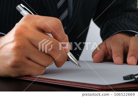 Business person signing documents 106522669