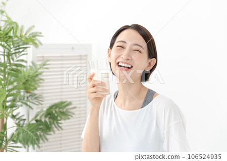 A woman drinking milk 106524935