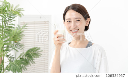 A woman drinking milk A woman drinking milk 106524937