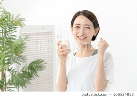 A woman drinking milk 106524938