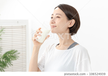 A woman drinking milk 106524939