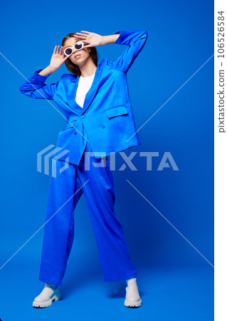 Fashion asian female model in blue suit, white boots and sunglasses. Fashion asian female model in blue suit, white boots and sunglasses. 106526584