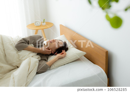 Woman in the bedroom, unwell 106528285