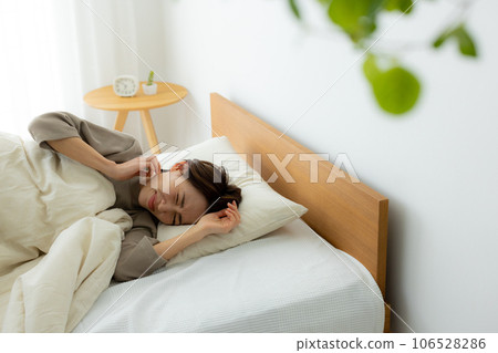 Woman in the bedroom, unwell 106528286