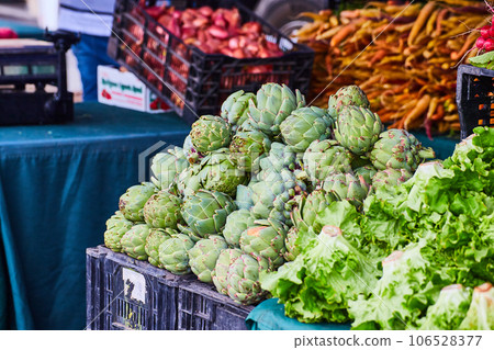 Close up of vegetables at farmers market with crates on tables 106528377