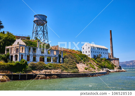 Close up view of abandoned and decaying building on Alcatraz Island with water tower 106528510
