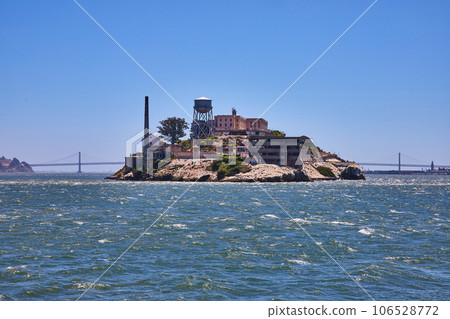Choppy San Francisco Bay waters with close view of Alcatraz Island and distant Golden Gate Bridge Choppy San Francisco Bay waters with close view of Alcatraz Island and distant Golden Gate Bridge 106528772