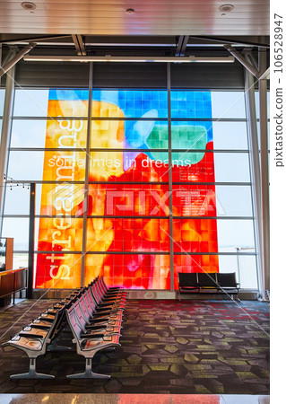 Poem window wall art with vibrant colors and empty airport terminal seating Poem window wall art with vibrant colors and empty airport terminal seating 106528947