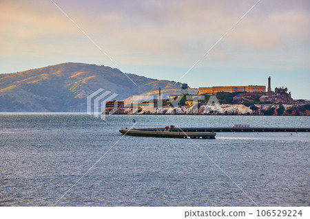 Mountain behind Alcatraz Island near sunset with Aquatic Cove 106529224