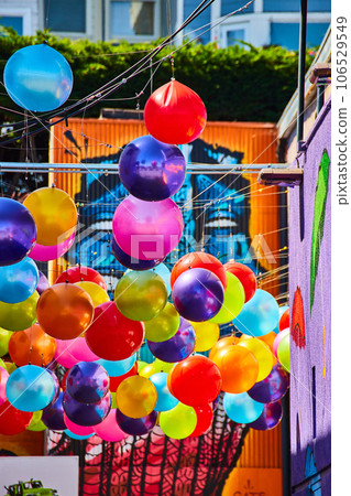 Vibrant and colorful hanging balloon balls with mural art Vibrant and colorful hanging balloon balls with mural art 106529549