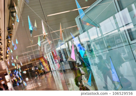 Abstract glass art on glass window with abstract geometric shapes and reflection of people Abstract glass art on glass window with abstract geometric shapes and reflection of people 106529556