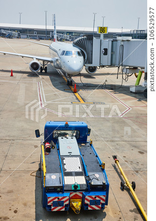 Ground vehicle parked near American Eagle airplane docked at terminal B6 106529577