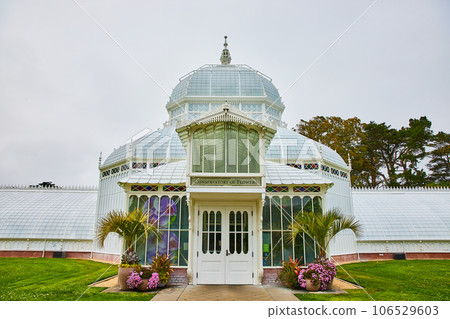 Exterior entrance to Conservatory of Flowers with plants around doorway 106529603