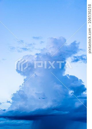 Cumulonimbus clouds rising in the late summer evening sky and rain columns below, high chroma contrast Cumulonimbus clouds rising in the late summer evening sky and rain columns below, high chroma contrast 106530258