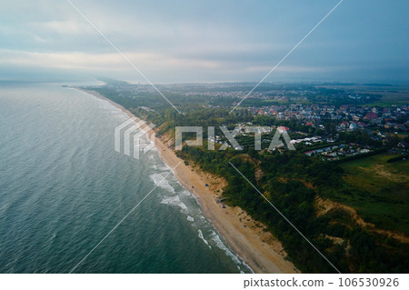 Aerial view of sea landscape with sand beach in Wladyslawowo. Baltic sea coastline in Poland. Resort town in summer season Aerial view of sea landscape with sand beach in Wladyslawowo. Baltic sea coastline in Poland. Resort town in summer season 106530926