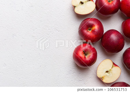 Fresh red apples with green leaves on wooden table. On wooden background. Top view free space for text Fresh red apples with green leaves on wooden table. On wooden background. Top view free space for text 106531753