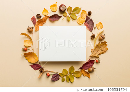 Autumn composition with paper blank and dried leaves on table. Flat lay, top view, copy space 106531794