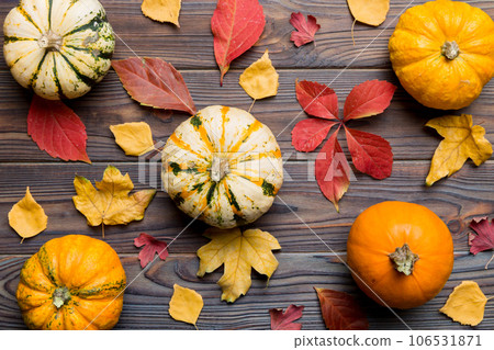 Autumn composition. Pattern made of dried leaves and other design accessories on table. Flat lay, top view Autumn composition. Pattern made of dried leaves and other design accessories on table. Flat lay, top view 106531871