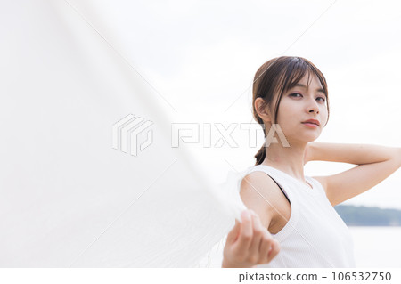 Refreshing woman standing on the beach 106532750