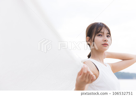 Refreshing woman standing on the beach Refreshing woman standing on the beach 106532751