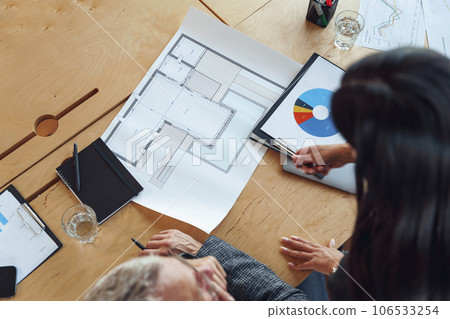 Top view of professional design engineers working with project documents in modern office  106533254