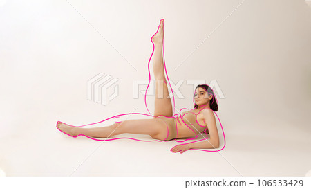 Portrait of fit girl in lingerie doing yoga with drawn silhouette overweight woman around body against studio background. Wellness. 106533429