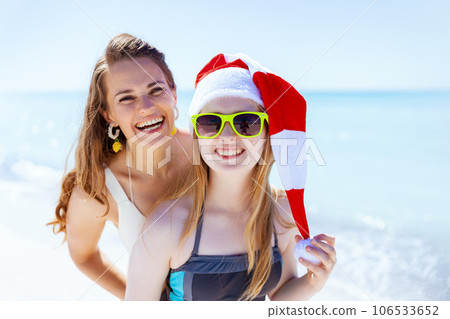 smiling stylish mother and child at beach having fun time 106533652