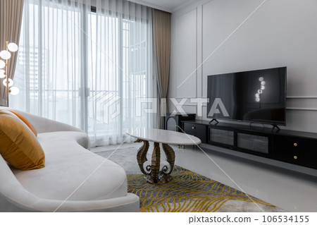 sofa with television and TV cabinet a luxurious white living room with a cozy style at a penthouse 106534155