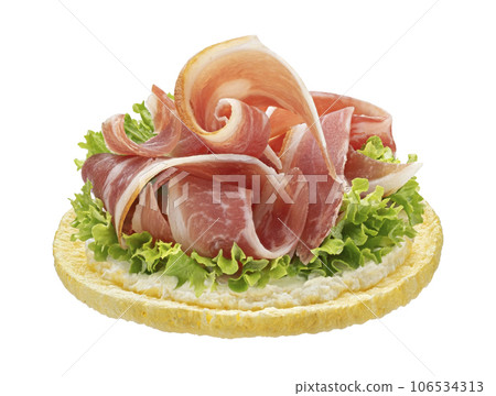 Puffed corn cake with smoked bacon slices isolated on white background 106534313