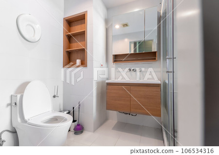 Modern luxury white bathroom interior ,There are marble floor decorated with wooden sink counter Modern luxury white bathroom interior ,There are marble floor decorated with wooden sink counter 106534316