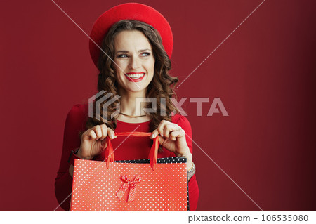 smiling stylish female in dress and beret on background 106535080