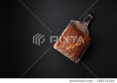 Delicious fresh crispy brown bread with grains and seeds Delicious fresh crispy brown bread with grains and seeds 106535268