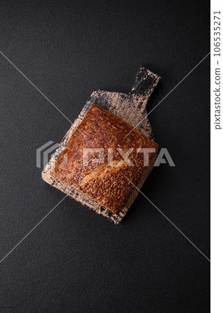 Delicious fresh crispy brown bread with grains and seeds Delicious fresh crispy brown bread with grains and seeds 106535271