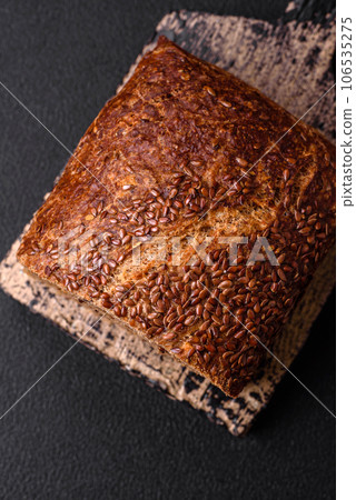 Delicious fresh crispy brown bread with grains and seeds Delicious fresh crispy brown bread with grains and seeds 106535275