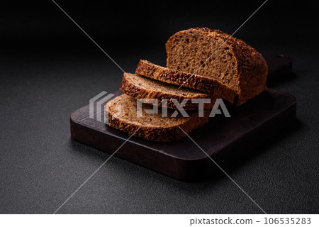 Delicious fresh crispy brown bread with grains and seeds 106535283