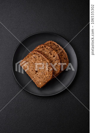 Delicious fresh crispy brown bread with grains and seeds 106535302
