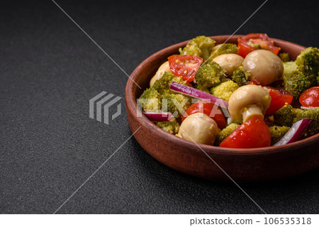Delicious fresh salad with broccoli, cherry tomatoes, mushrooms, onions, salt, spices and herbs Delicious fresh salad with broccoli, cherry tomatoes, mushrooms, onions, salt, spices and herbs 106535318