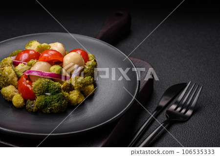 Delicious fresh salad with broccoli, cherry tomatoes, mushrooms, onions, salt, spices and herbs Delicious fresh salad with broccoli, cherry tomatoes, mushrooms, onions, salt, spices and herbs 106535333