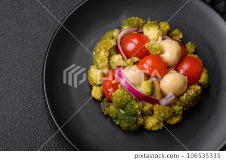 Delicious fresh salad with broccoli, cherry tomatoes, mushrooms, onions, salt, spices and herbs Delicious fresh salad with broccoli, cherry tomatoes, mushrooms, onions, salt, spices and herbs 106535335