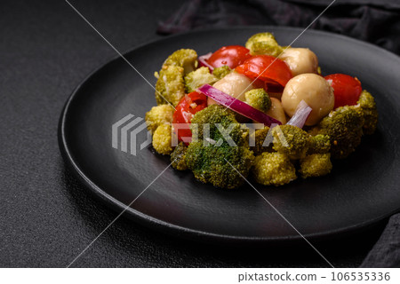 Delicious fresh salad with broccoli, cherry tomatoes, mushrooms, onions, salt, spices and herbs Delicious fresh salad with broccoli, cherry tomatoes, mushrooms, onions, salt, spices and herbs 106535336