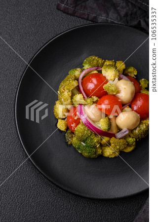 Delicious fresh salad with broccoli, cherry tomatoes, mushrooms, onions, salt, spices and herbs Delicious fresh salad with broccoli, cherry tomatoes, mushrooms, onions, salt, spices and herbs 106535337