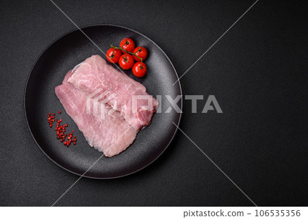 A piece of fresh juicy raw pork with salt, spices and herbs 106535356