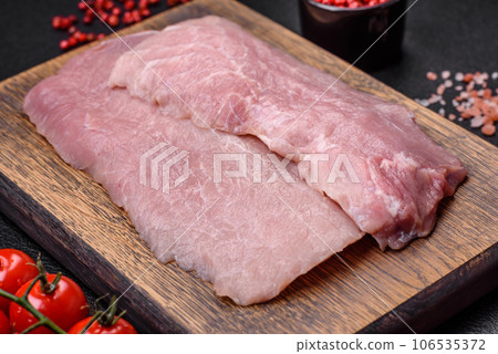 A piece of fresh juicy raw pork with salt, spices and herbs 106535372